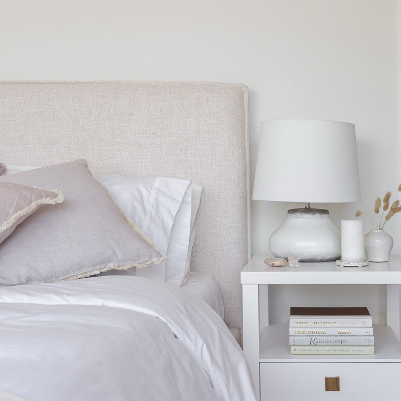 Front view highlighting the soft textured upholstery and the clean architectural lines of the bed frame
