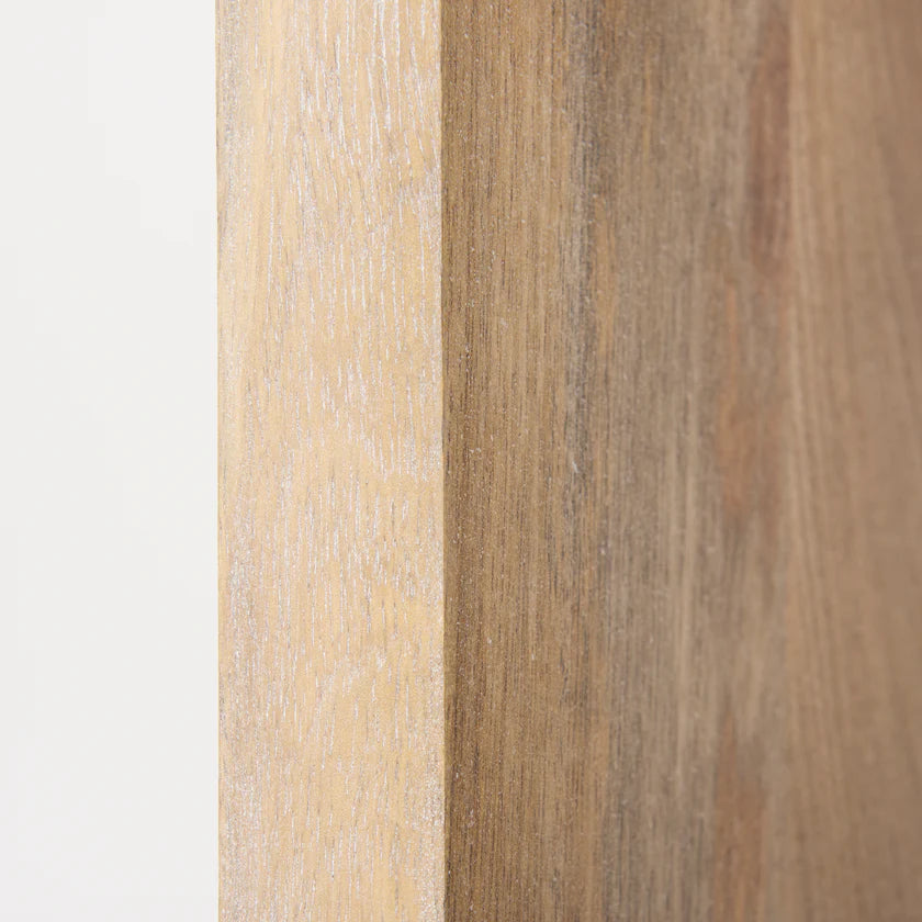 Three-quarter perspective view of the Traro shelving unit in blonde wood featuring a unique geometric honeycomb compartment design