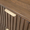 Macro detail shot focusing on the tactile vertical wood slats and the modern low-profile brass hardware