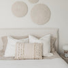 Close-up shot of the headboard featuring a unique flanged edge border and soft tactile cream fabric