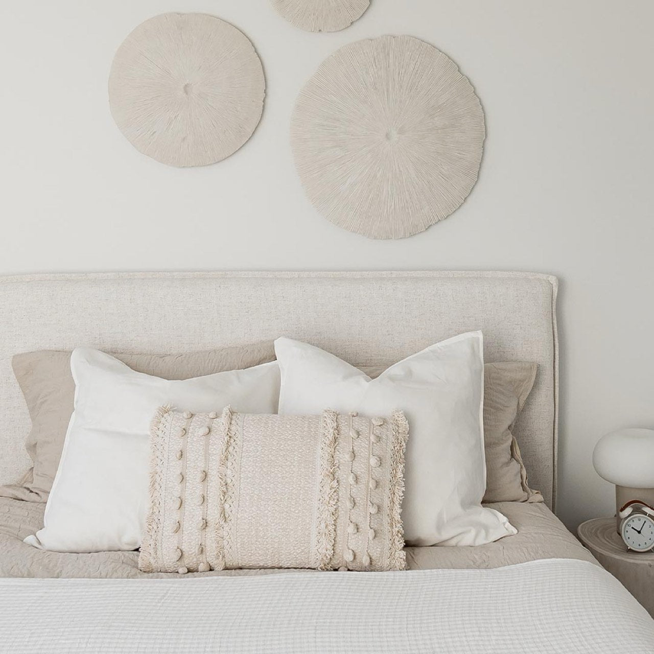 Front view highlighting the soft textured upholstery and the clean architectural lines of the bed frame