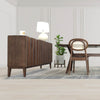 Perspective lifestyle shot featuring the sideboard styled with organic accents in a high-end interior setting alongside a wood dining table
