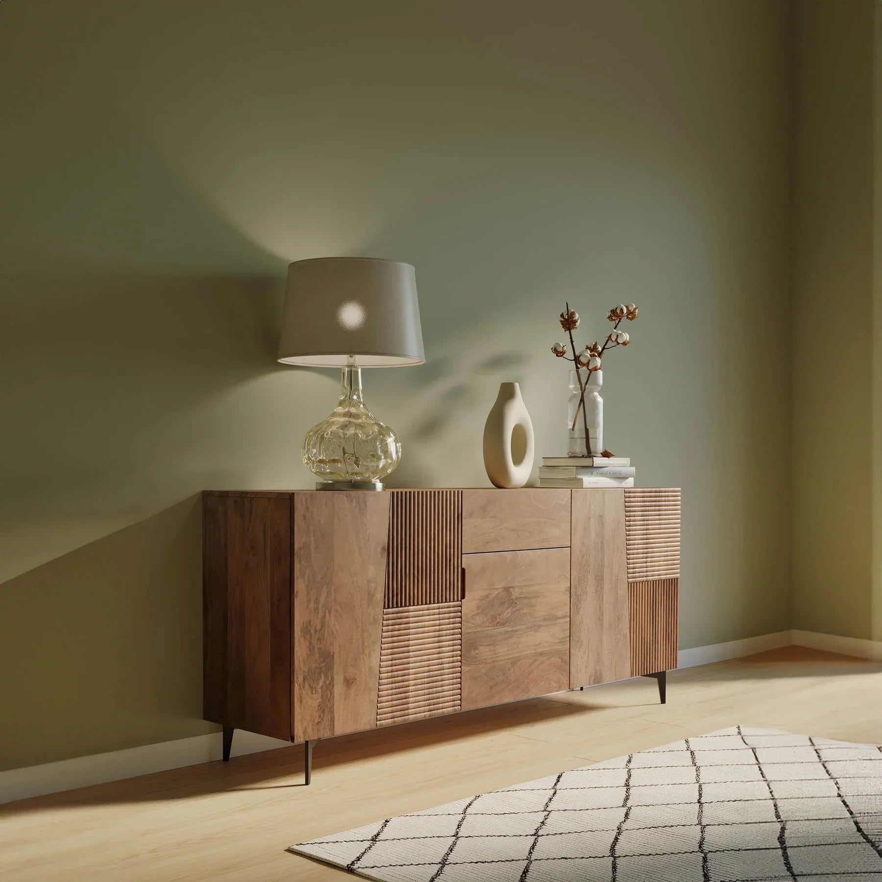 Front view of the Peyton sideboard featuring natural mango wood construction with unique geometric carved door panels and black metal legs