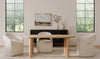 Lifestyle shot featuring the Milo table in a bright, modern dining space styled with neutral barrel chairs and a black sideboard