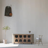 Lifestyle shot featuring the Colosseo sideboard styled in a bright minimalist room with a single plant and neutral wall decor
