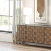 Lifestyle shot focusing on the top surface of the leather sideboard styled with a wooden bowl and modern framed art