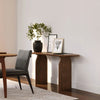 Lifestyle shot featuring the Domingo console table styled in a contemporary space with minimalist decor and greenery
