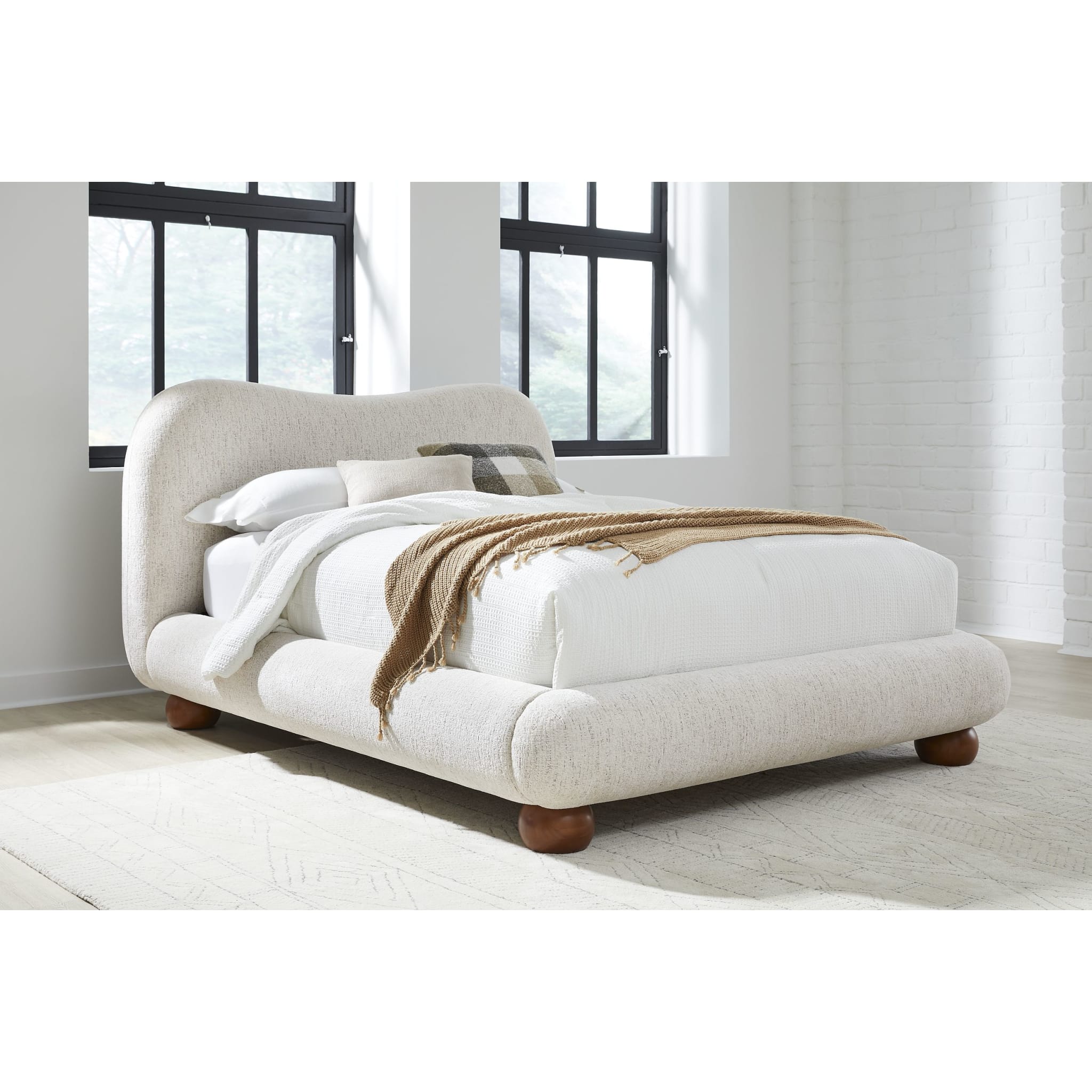 Front view of the Afra upholstered bed featuring a soft cream chenille fabric and a modern wave-shaped rounded headboard