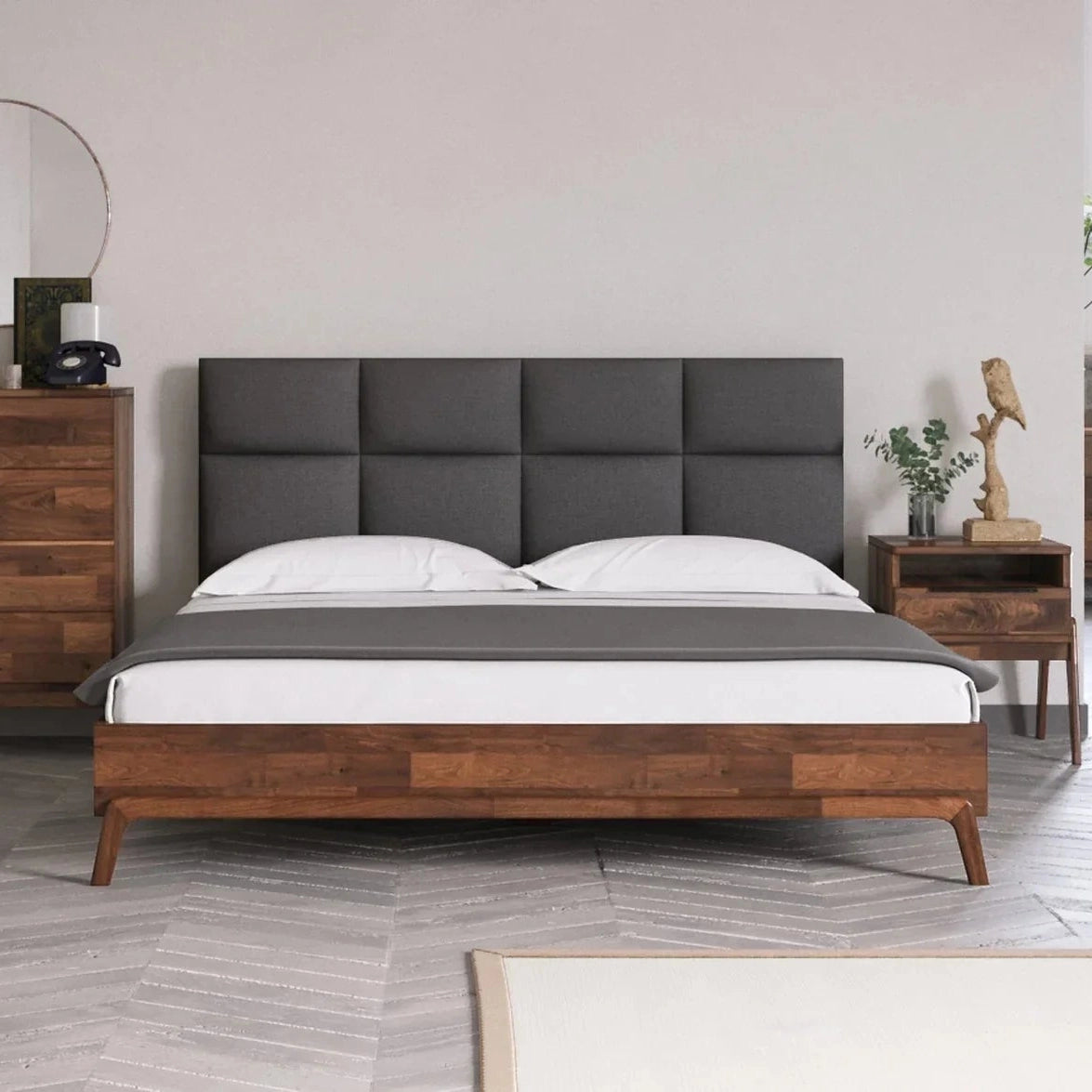 Studio lifestyle shot showcasing the bed styled with matching dark wood nightstands in a clean contemporary setting