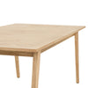 High-angle perspective view showcasing the expansive rectangular tabletop and the warm organic aesthetic of the natural oak