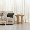 Interior lifestyle view featuring the arch side table styled with a small plant next to a contemporary neutral-toned sofa