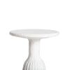 Three-quarter high-angle view highlighting the smooth circular tabletop and the tapered transition to the fluted base