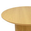 Three-quarter perspective view highlighting the clean architectural lines and the elegant tapered edge of the circular tabletop