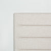 Macro shot focusing on the upper corner of the headboard showcasing the smooth fabric wrap and sturdy construction