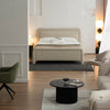 Rear perspective view highlighting the fully upholstered finish and the sturdy integrated leg design of the Alba bed