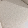 Detailed view where the plush seat meets the upholstered pedestal base