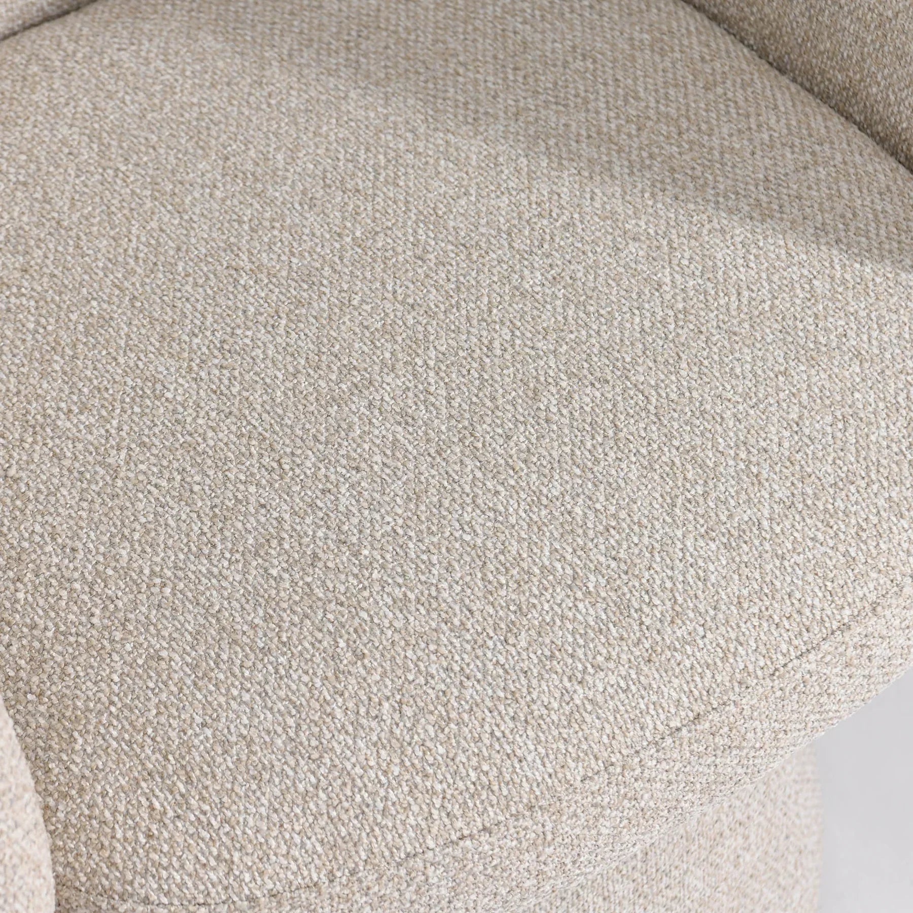 Detailed view where the plush seat meets the upholstered pedestal base