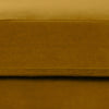 Macro shot of the velvet upholstery demonstrating the soft texture and vibrant mustard color