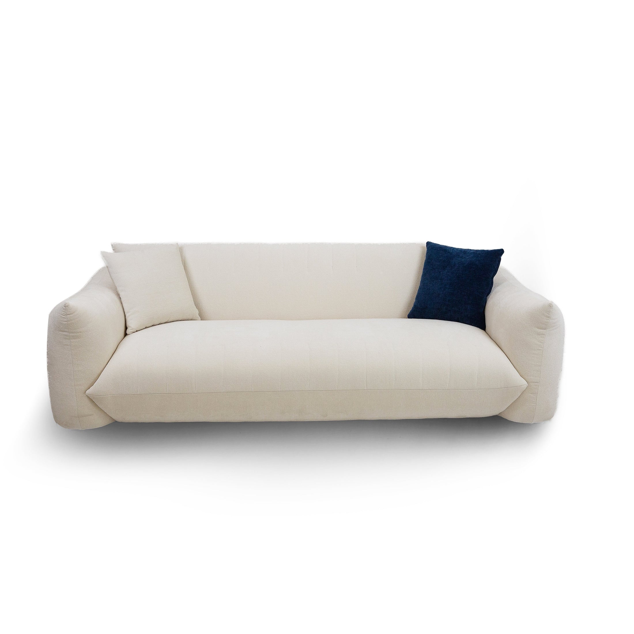 Front view of Moa cream sofa with deep seating and navy accent pillow