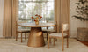Lifestyle shot showcasing the Tutto table paired with light-colored upholstered chairs in a bright minimalist dining space