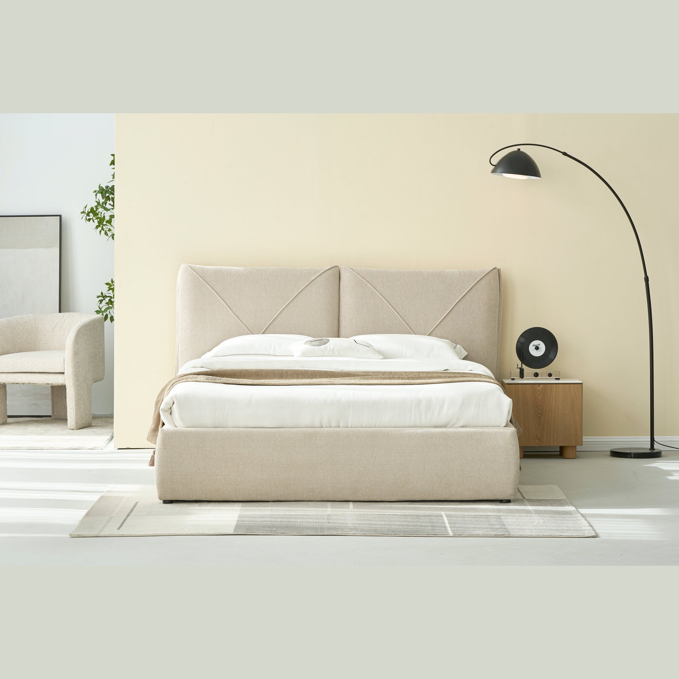 Front view of the Aici storage bed featuring a cream fabric finish and a unique V-shaped geometric stitched headboard