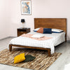 Lifestyle shot featuring the Allure bed styled with a white and orange patterned duvet in a bright master suite