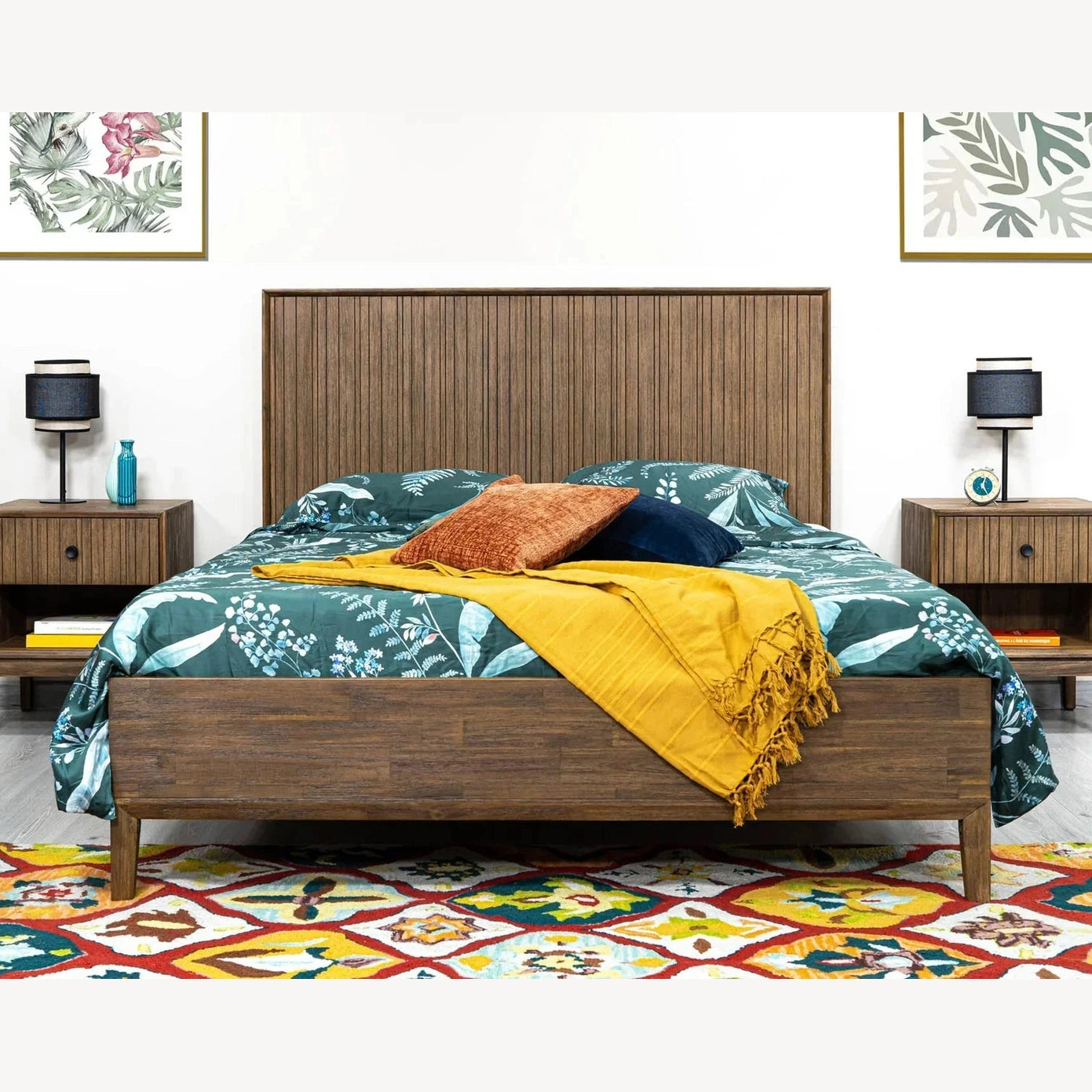 Front view of the West king platform bed featuring a tall vertical slatted wood headboard in a rich walnut finish