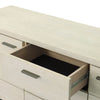 Close-up shot focusing on the minimalist black metal drawer handle and the fine grain of the white ash wood