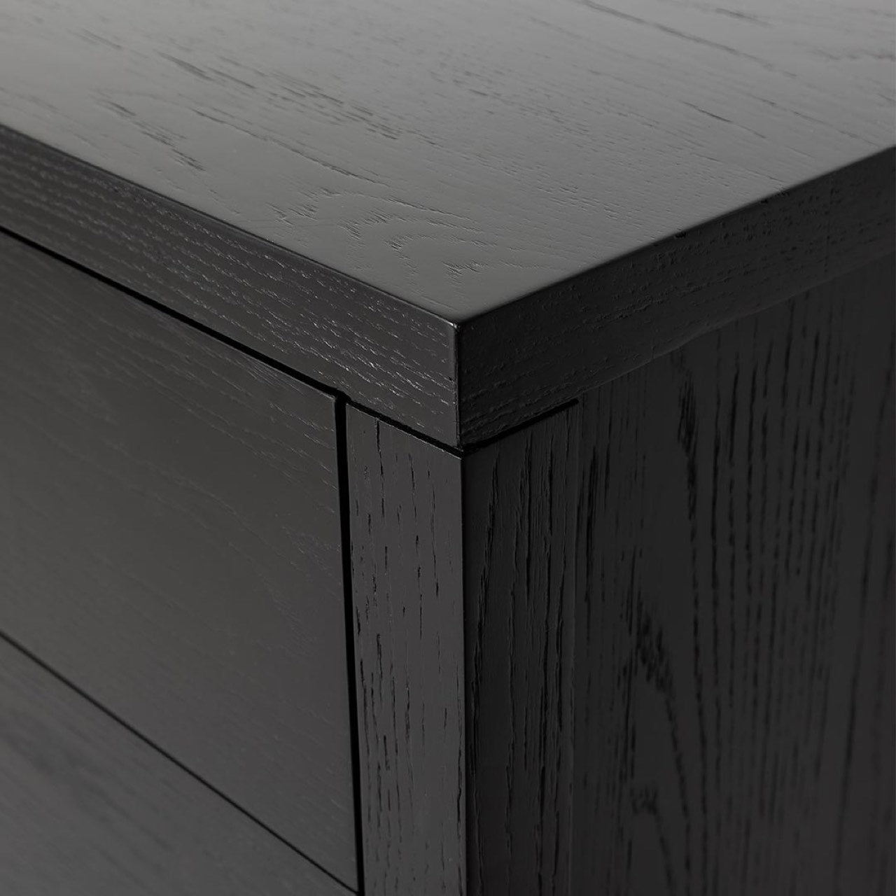 High-angle perspective focusing on the seamless top corner construction and the durable textured oak grain