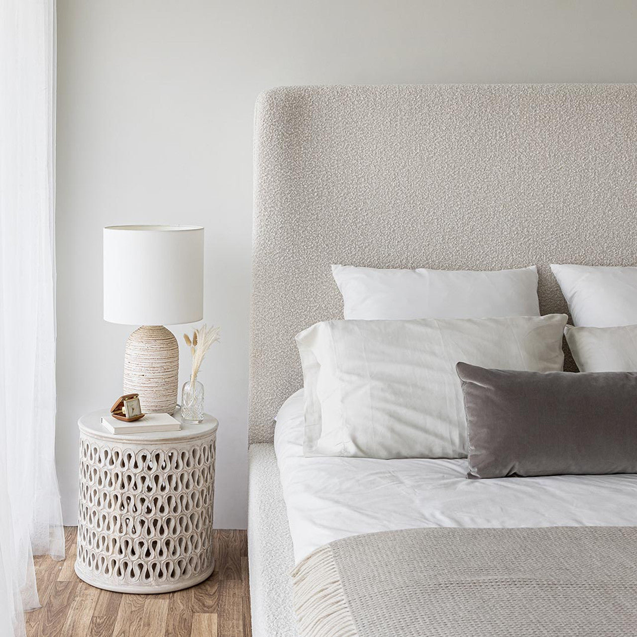 Front view of the Aino queen platform bed featuring a tall curved wingback headboard and off-white bouclé upholstery
