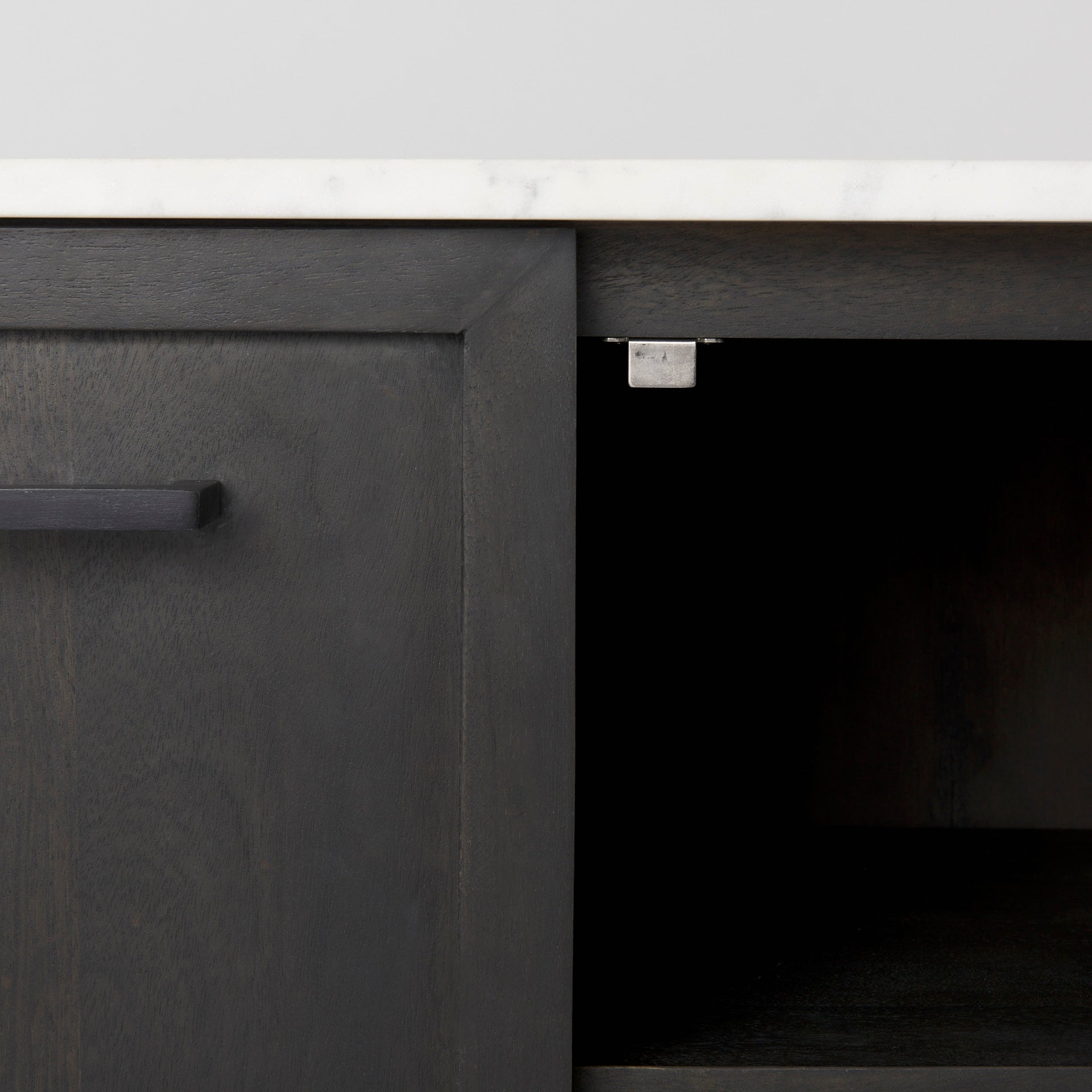 Front perspective view of the Gemma sideboard featuring a dark charcoal wood finish, a white marble top, and slim black metal legs