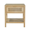 Straight-on front view showcasing the woven rattan drawer front and minimalist brass hardware on a light wood frame