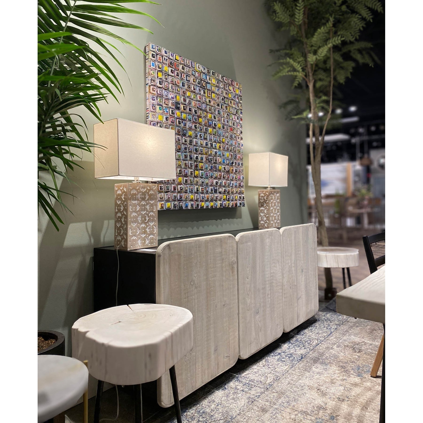 Three-quarter perspective view of the Renaissance sideboard featuring a deep charcoal mango wood finish and hand-carved textured relief panels across four doors