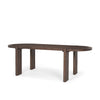 Three-quarter perspective view showcasing the elongated oval tabletop and architectural trestle base of the dark wood table