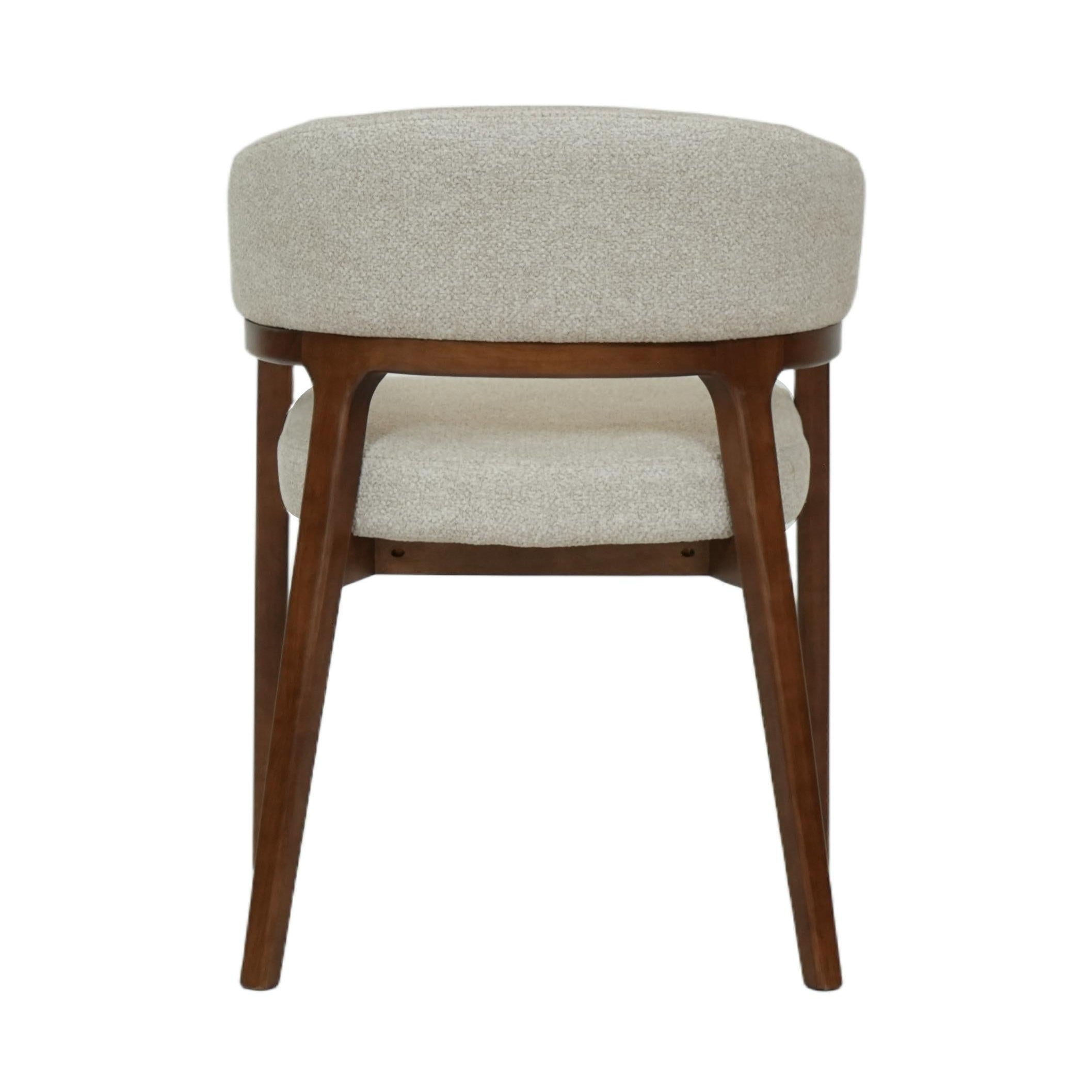Front view of the Vinda dining chair featuring light grey fabric upholstery and slim black tapered metal legs