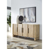 Lifestyle shot featuring the Nelly sideboard styled in a contemporary dining space with wall art and decorative objects