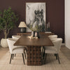 Lifestyle shot featuring the Trellyn table in a dark, moody interior styled with neutral upholstered chairs and horse artwork