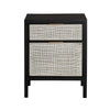 Straight-on front view highlighting the symmetrical black frame and the organic texture of the light-toned rattan drawer inserts