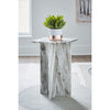 Lifestyle shot of the square grey marble table styled with a small potted plant in a bright minimalist interior setting