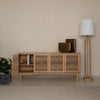 Lifestyle shot highlighting the sideboard used for office storage, styled with framed art and olive trees