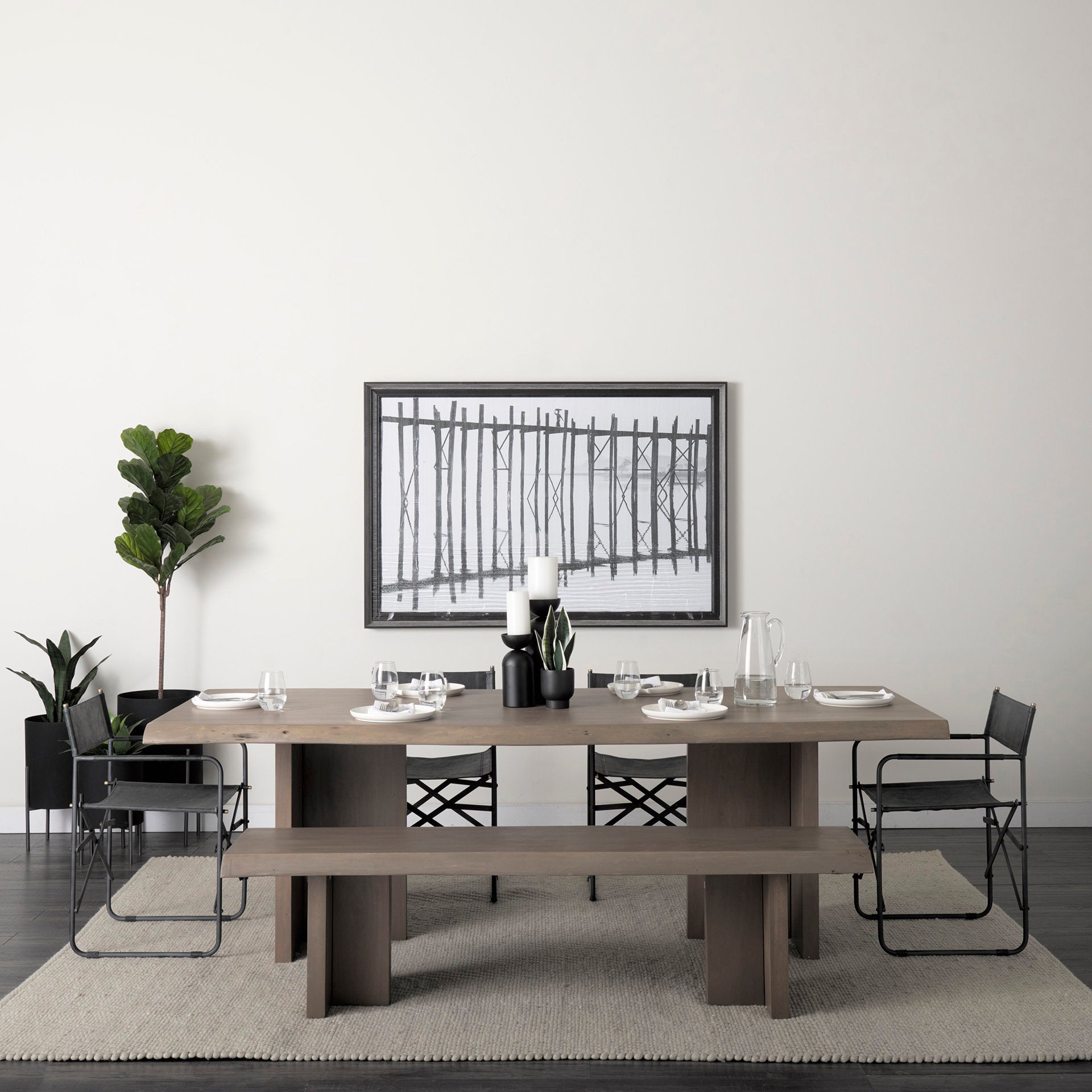 Front view of the Konstantin rectangular dining table featuring a medium brown wood finish with a natural live edge and thick slab pedestal legs