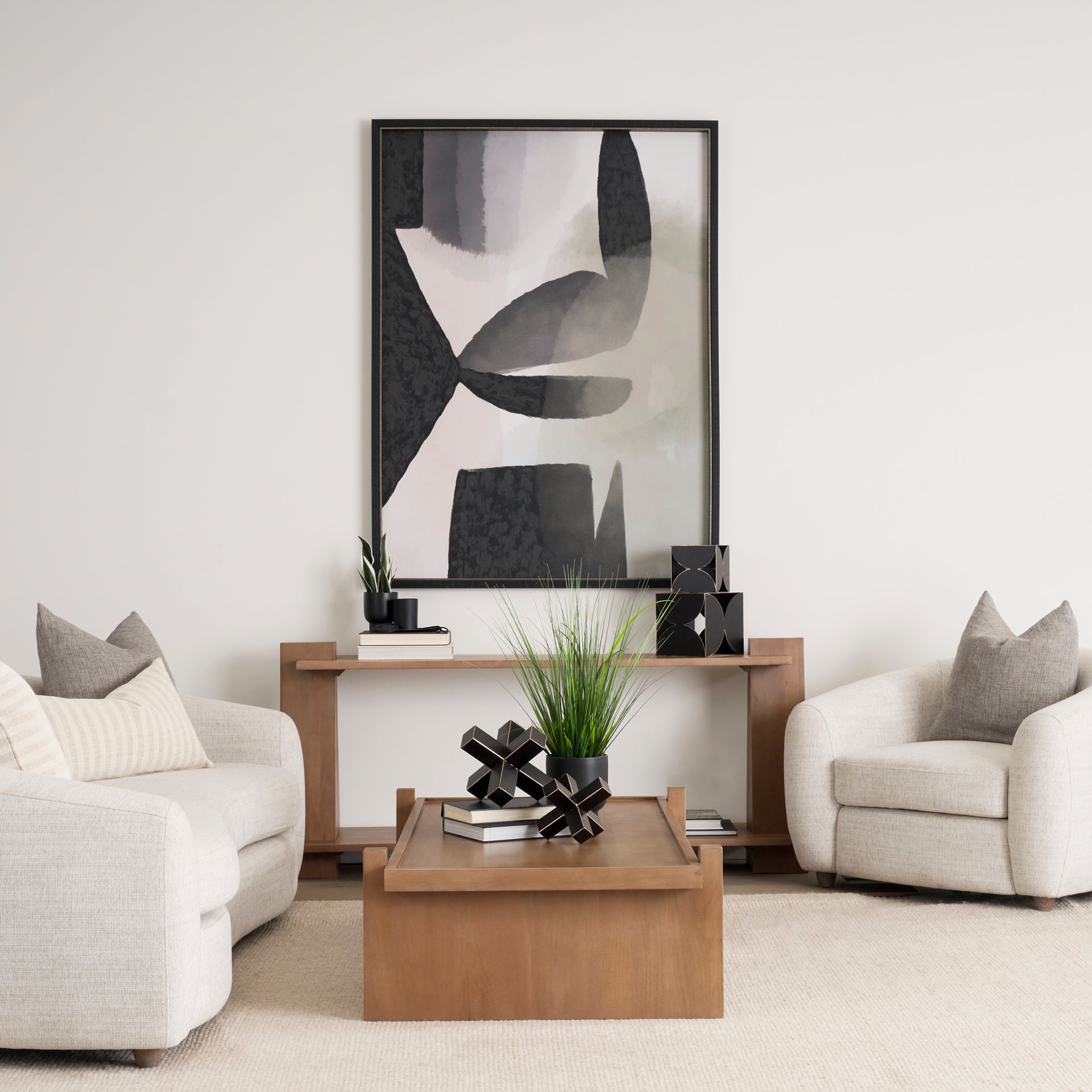 Lifestyle shot featuring the Eula console table styled as a sofa table in a contemporary living room setting