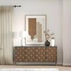 Lifestyle shot featuring the brown leather sideboard styled in a bright room with abstract wall art and a white table lamp