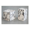 Perspective shot of two Calacatta Viola marble plinths in different heights showcasing the natural stone patterns and polished block silhouette