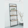 Lifestyle shot of the wall-mounted rack in a bright white room styled with small plants and books