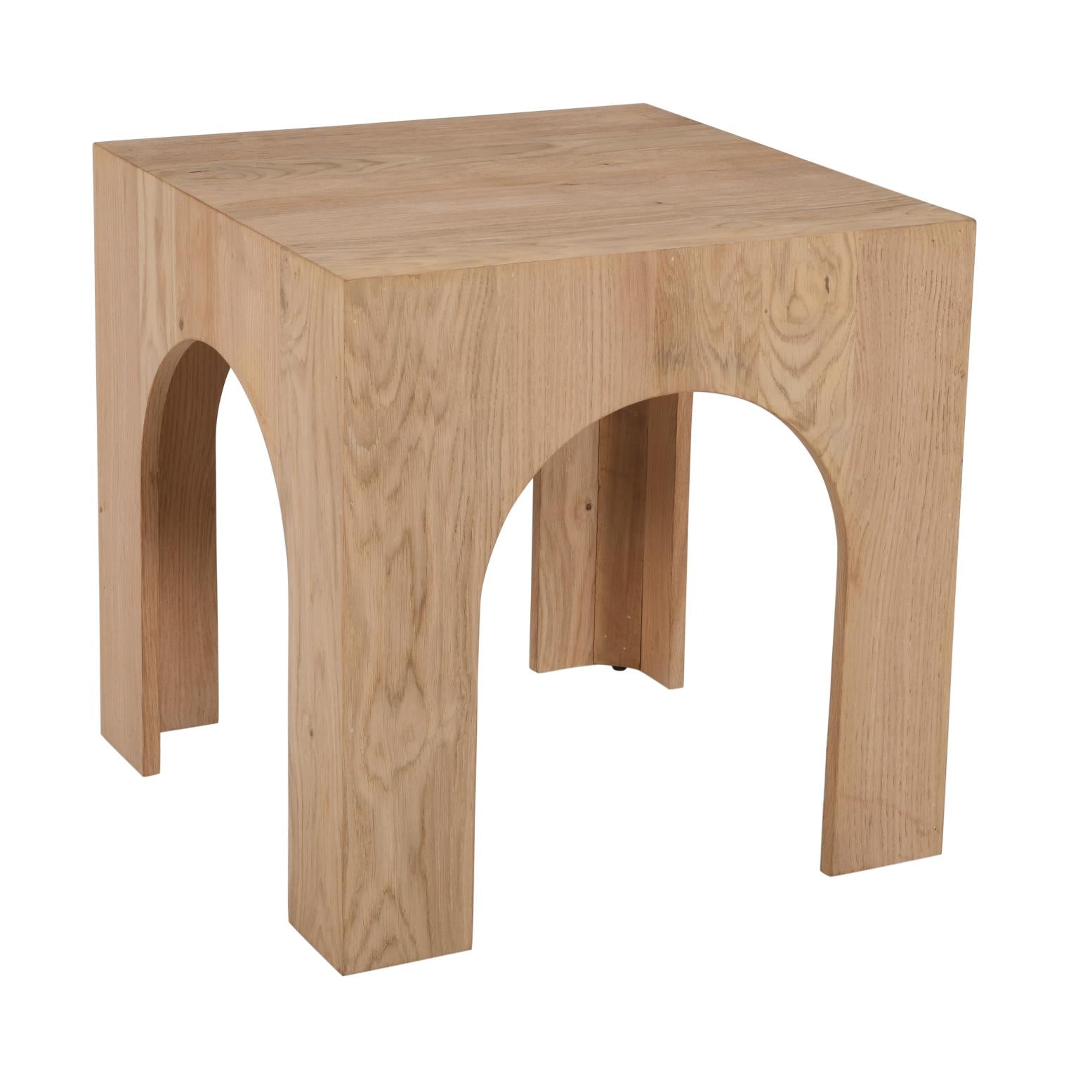 Front view of the Archimedes end table featuring a square top and a unique sculptural base with deep architectural arches crafted from light natural oak