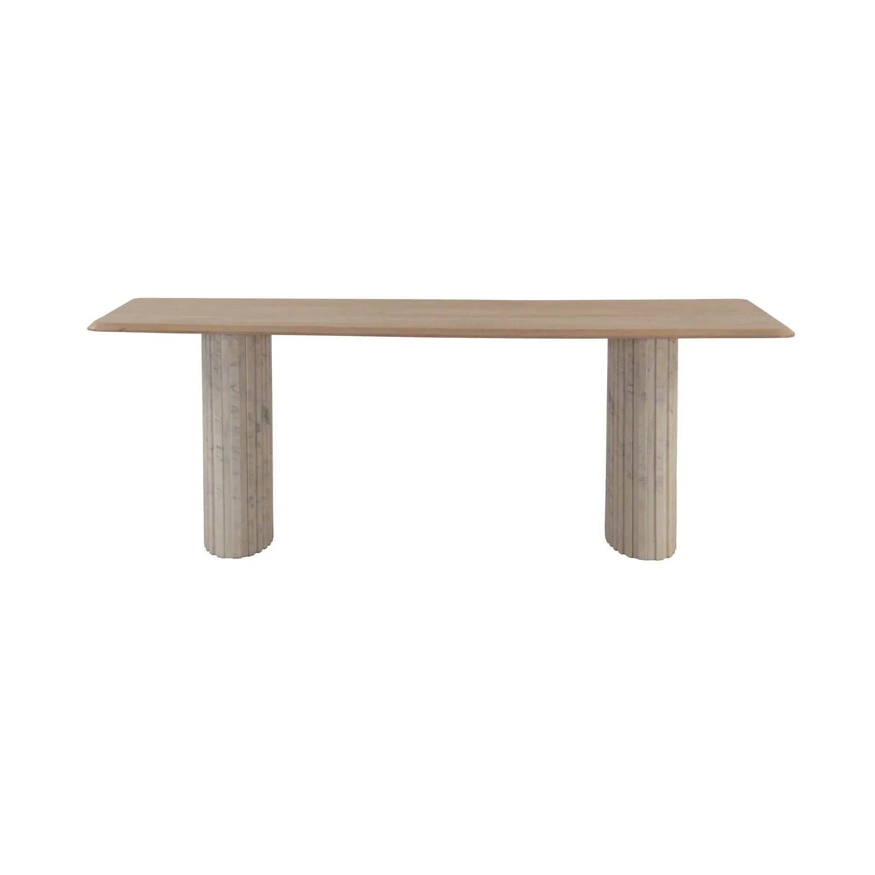 Front view of the Hedron dining table in a natural oak finish featuring rounded corners and two thick ribbed pedestal legs