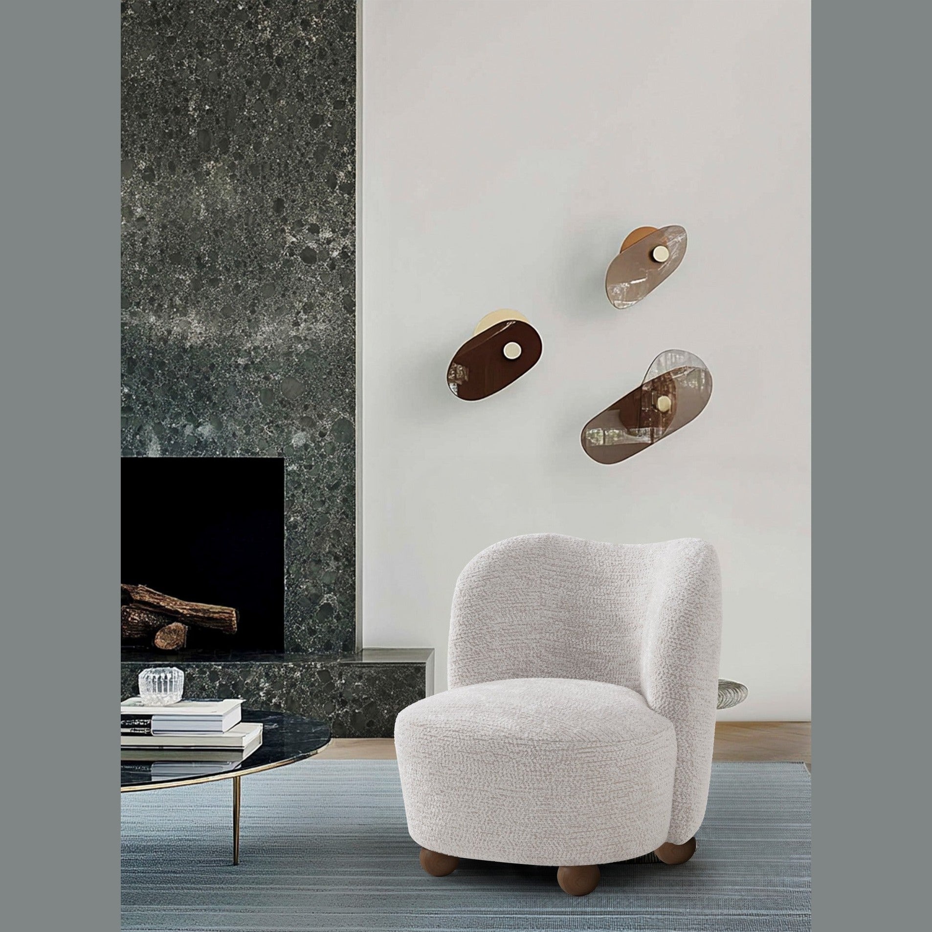 Saga Accent Chair in Oatmeal bouclé fabric featuring a rounded silhouette and wooden ball feet.