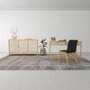 Wide-angle lifestyle shot featuring the rattan sideboard alongside a matching natural wood desk and black office chair