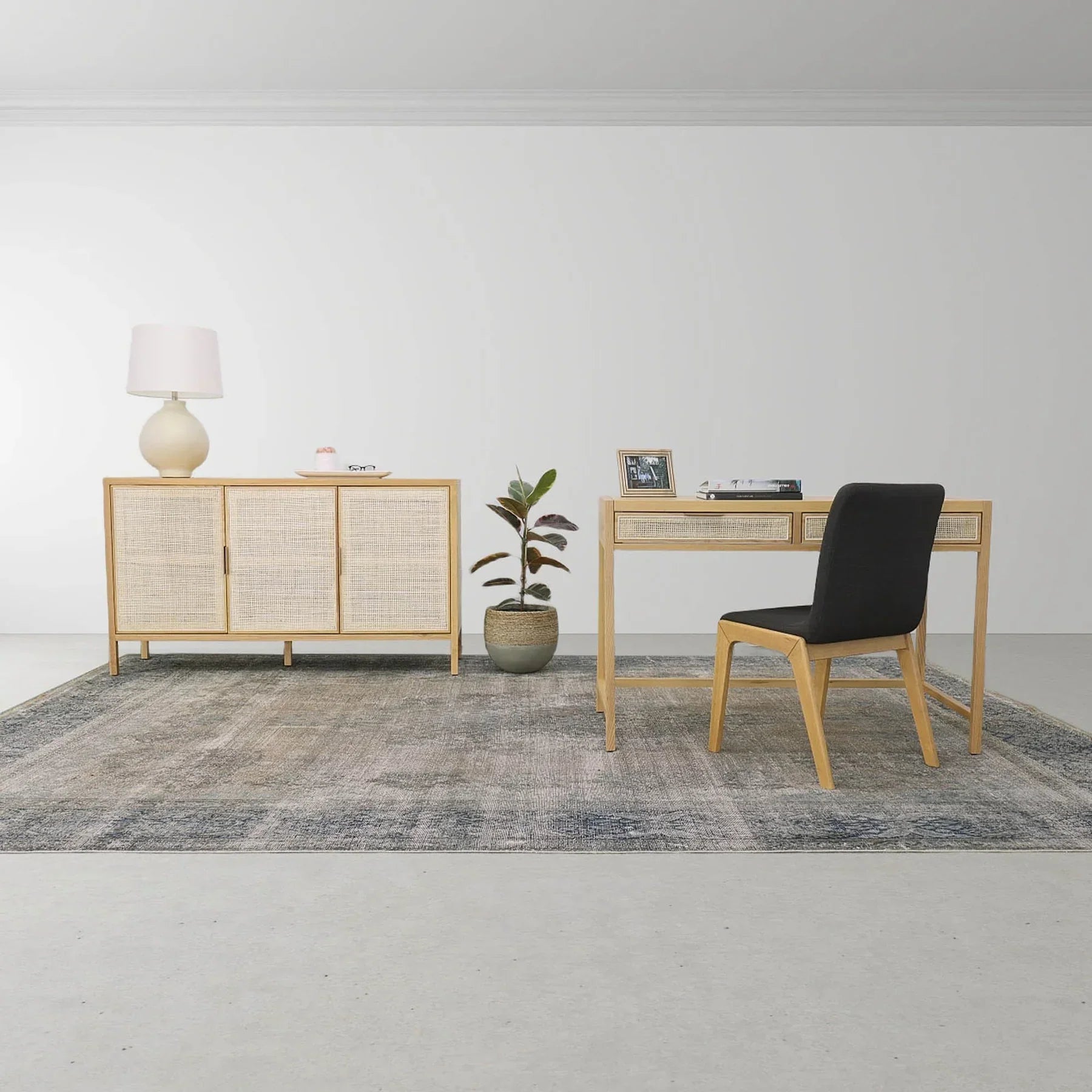 Straight-on front view highlighting the symmetrical three-door layout and the organic texture of the light-toned rattan panels
